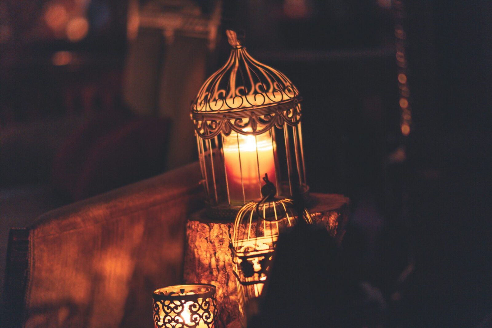 A glowing candle inside an ornate lantern creates a warm ambiance perfect for festive occasions like Ramadan.