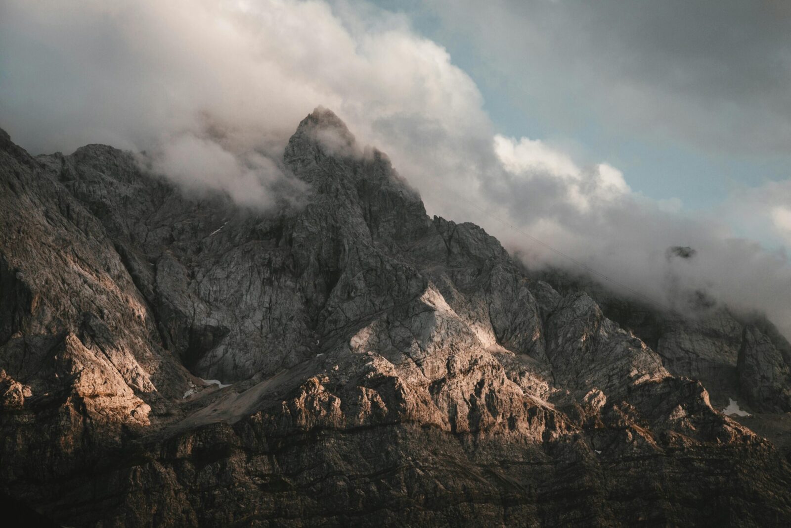 Captivating view of a rocky mountain landscape shrouded in misty clouds.