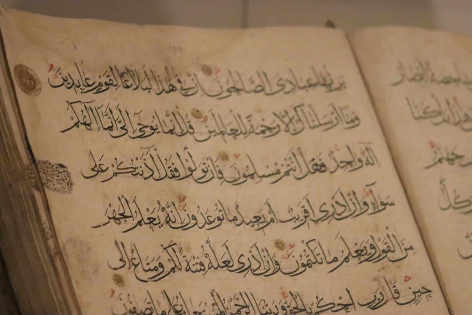 A detailed view of ancient book pages showcasing intricate Arabic calligraphy.