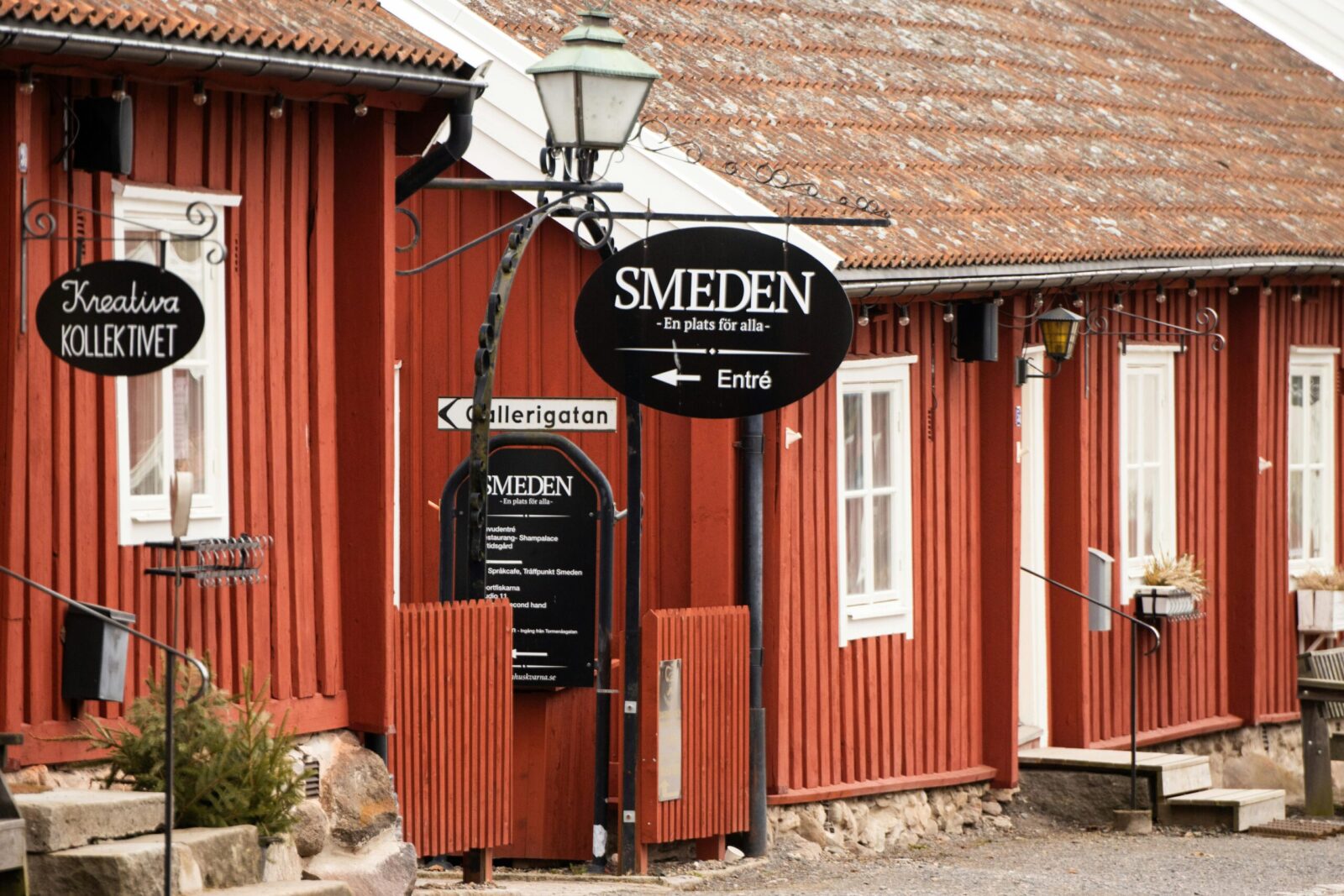 Traditional red wooden house with signage in Huskvarna, Jonkoping County, Sweden.