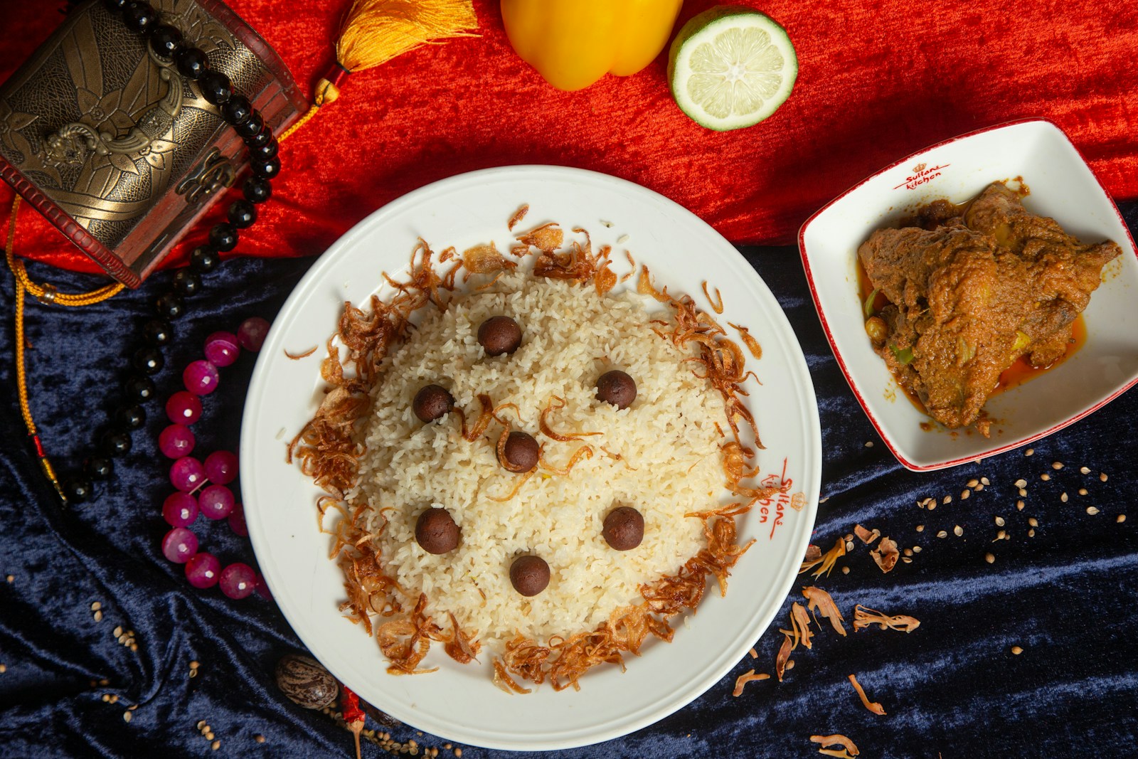a white plate topped with food next to a bowl of food
