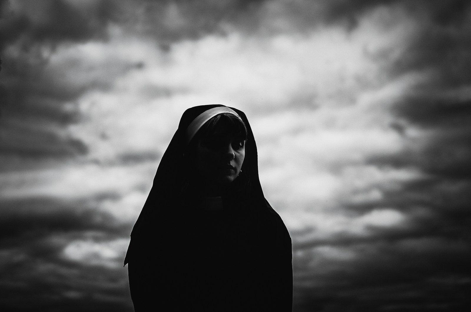 a black and white photo of a woman in a hoodie