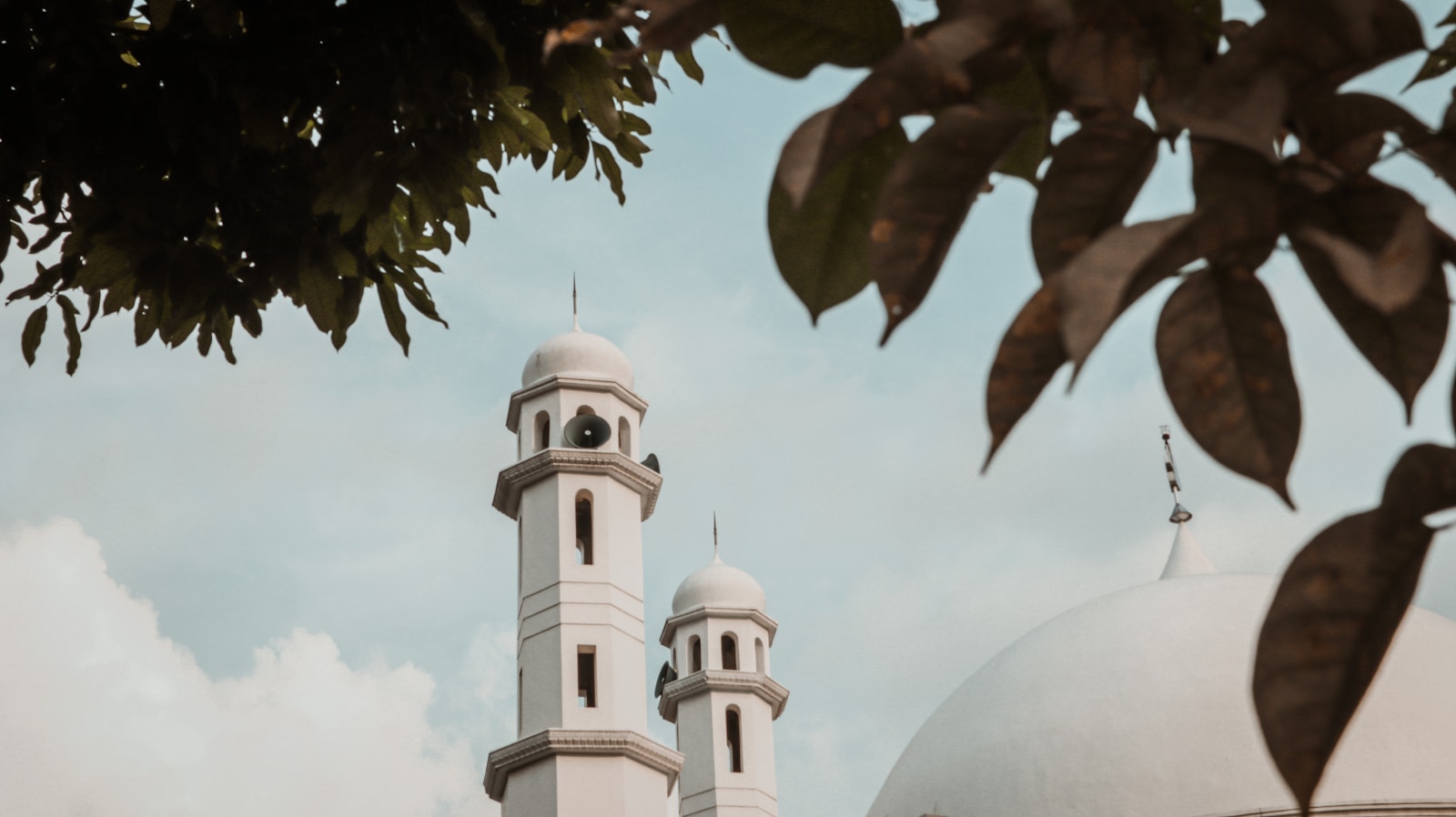 a large white building with a clock on it's side