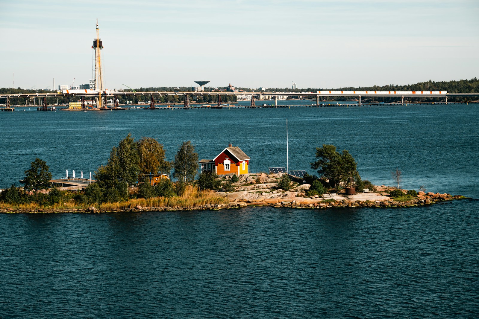 A small island in the middle of a large body of water