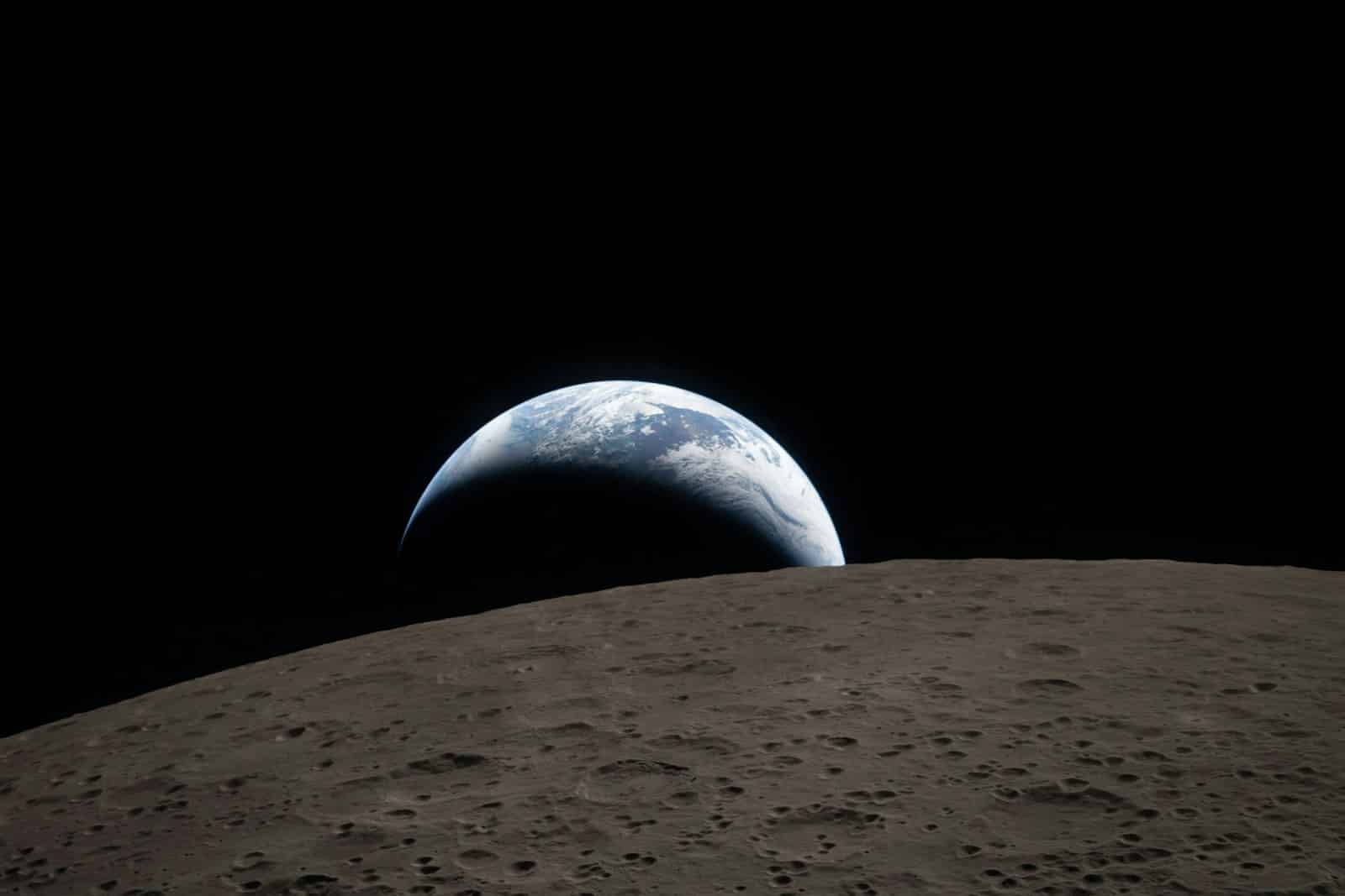 Earth rising over the moon's surface
